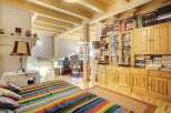 This charming property boasts a cozy bedroom with a vibrant, striped bedspread.