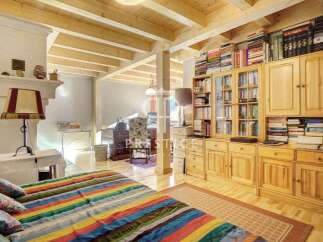 This charming property boasts a cozy bedroom with a vibrant, striped bedspread.