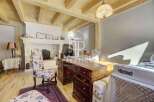 Discover the charm of this exquisite property, featuring a cozy fireplace and elegant wooden beams.
