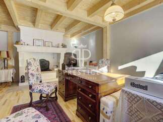 Discover the charm of this exquisite property, featuring a cozy fireplace and elegant wooden beams.