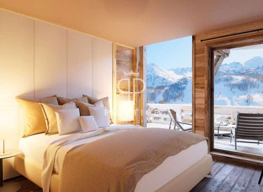 Experience luxury living in this stunning bedroom with breathtaking mountain views.