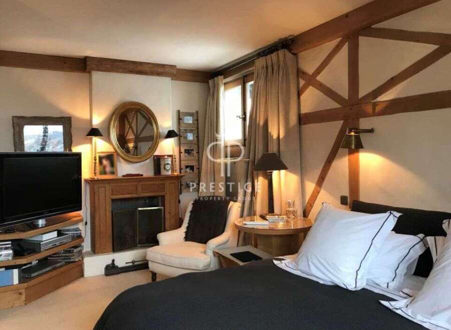 Cozy bedroom with a fireplace and a comfortable bed.