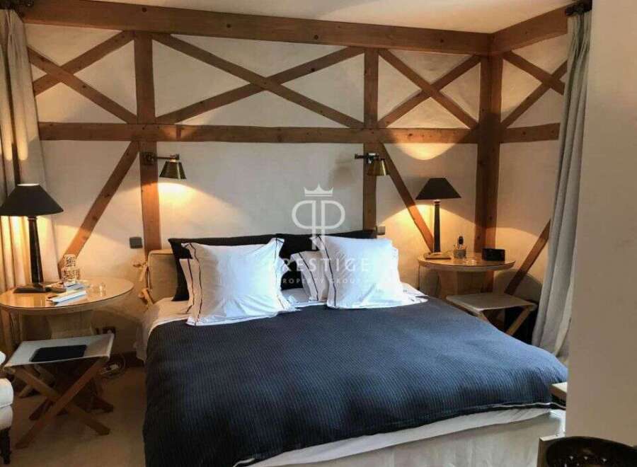 Discover the charm of this exquisite bedroom, featuring a unique wooden beam design that adds character and warmth.