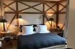 Discover the charm of this exquisite bedroom, featuring a unique wooden beam design that adds character and warmth.