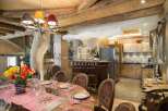 Experience luxury living in this stunning property, featuring a unique antler chandelier and rustic wooden beams.