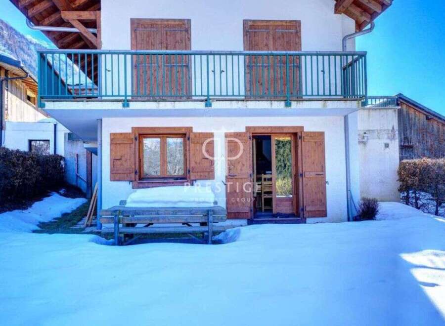 Charming chalet nestled in a snowy landscape, perfect for a winter getaway.