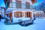 Discover a charming property nestled in a snowy landscape, perfect for a cozy retreat.