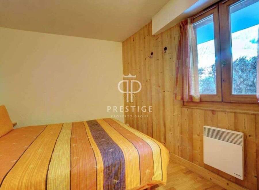 Cozy bedroom with wooden accents and a warm, inviting atmosphere.