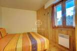 Cozy bedroom with wooden accents and a warm, inviting atmosphere.