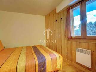 Cozy bedroom with wooden accents and a warm, inviting atmosphere.