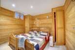 Cozy bedroom with wooden paneling, perfect for a relaxing getaway.
