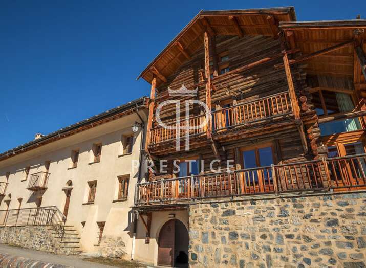 Discover the charm of this stunning property, featuring a unique blend of rustic log construction and elegant stone facade.