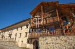 Discover the charm of this stunning property, featuring a unique blend of rustic log construction and elegant stone facade.