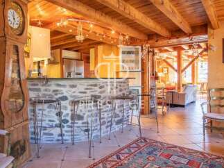 Step into rustic elegance with this stunning property, featuring a charming stone bar and a grand grandfather clock.