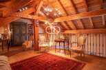 Discover the charm of this stunning property, featuring a beautifully designed interior with exposed wooden beams and a cozy ambiance.