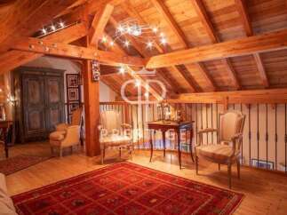 Discover the charm of this stunning property, featuring a beautifully designed interior with exposed wooden beams and a cozy ambiance.
