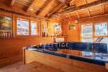 Discover the ultimate relaxation in this stunning wooden cabin, complete with a luxurious hot tub.