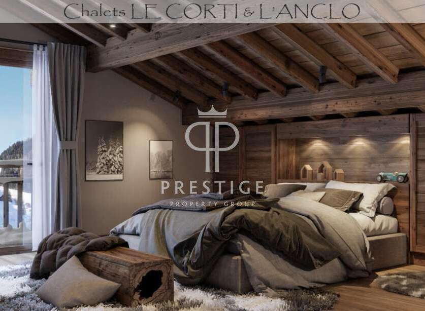 Experience luxury living in this stunning chalet, featuring a cozy bedroom with a rustic wooden ceiling and walls.