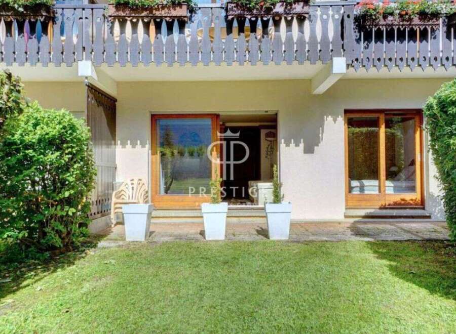 Discover a charming property with a beautiful balcony and lush greenery.