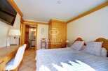 Discover a cozy bedroom with a charming wooden design.