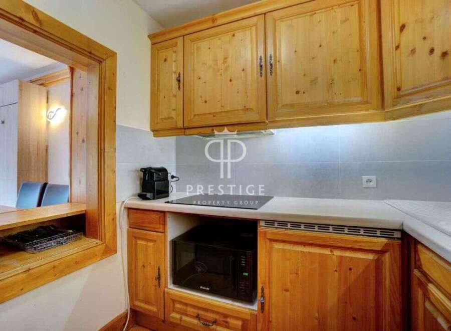 Discover a charming kitchen with warm wooden cabinetry, perfect for culinary enthusiasts.