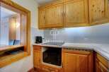 Discover a charming kitchen with warm wooden cabinetry, perfect for culinary enthusiasts.