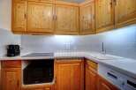 Discover this charming kitchen with its warm wooden cabinetry and modern appliances.