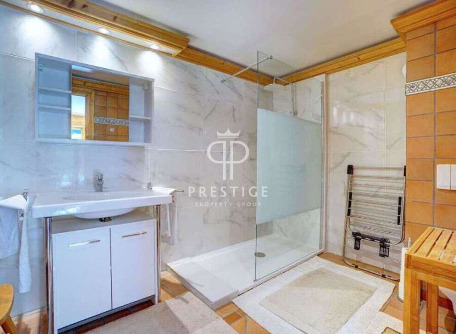 Discover a luxurious bathroom with a modern shower and elegant vanity.