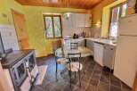 Charming kitchen with a rustic touch! This space features a classic stove, a cozy dining area, and ample natural light.