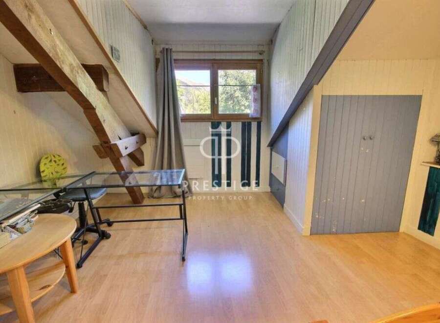 Discover the charm of this unique property, featuring exposed wooden beams and a cozy attic space.