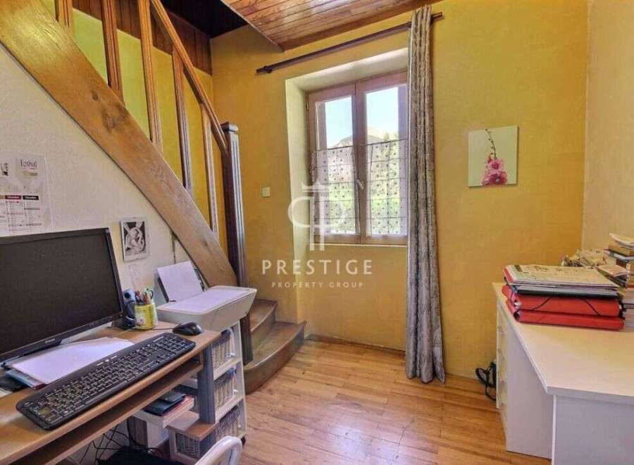 Discover the charm of this property, featuring a cozy workspace with a desk and a computer.