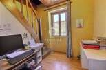 Discover the charm of this property, featuring a cozy workspace with a desk and a computer.