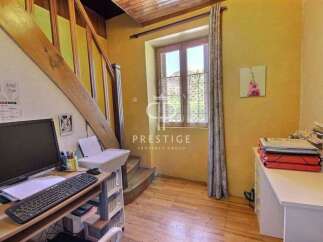 Discover the charm of this property, featuring a cozy workspace with a desk and a computer.