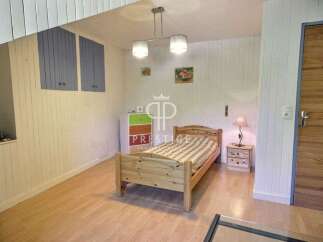 Discover a cozy bedroom with a charming wooden bed and a warm, inviting atmosphere.