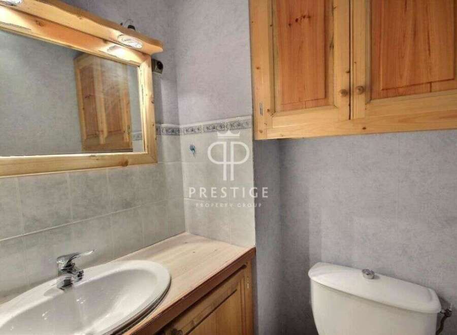 Discover this charming bathroom featuring a stylish vanity and a convenient toilet.