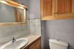 Discover this charming bathroom featuring a stylish vanity and a convenient toilet.