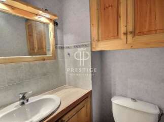 Discover this charming bathroom featuring a stylish vanity and a convenient toilet.