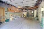 Discover the potential of this versatile property! This space features a sturdy concrete block construction, perfect for storage or a workshop.
