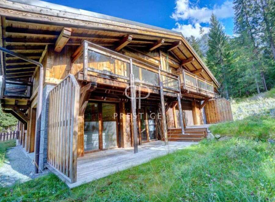 Discover a stunning wooden chalet nestled in a picturesque mountain setting.