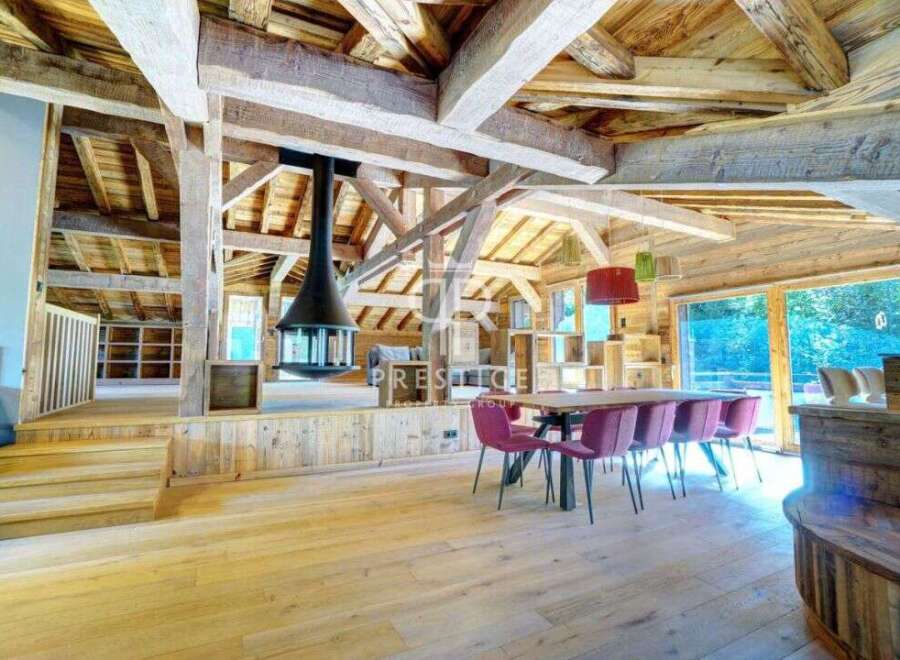 Experience rustic elegance in this stunning property, showcasing exposed wooden beams and a cozy fireplace.