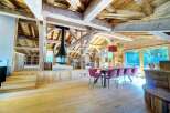 Experience rustic elegance in this stunning property, showcasing exposed wooden beams and a cozy fireplace.