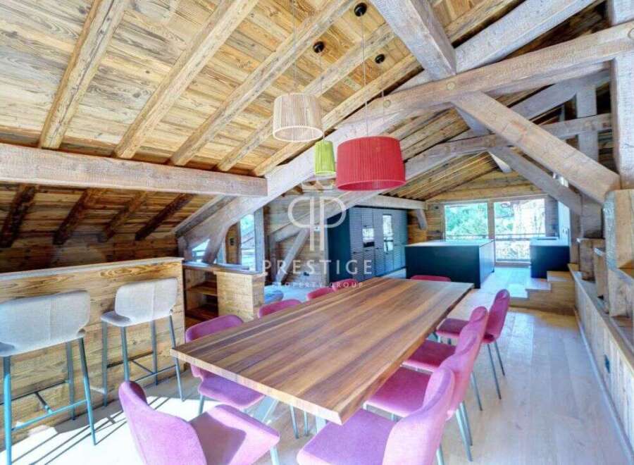 Experience luxury living in this stunning property, featuring a beautifully designed interior with exposed wooden beams and a modern kitchen.