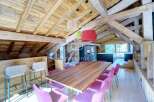 Experience luxury living in this stunning property, featuring a beautifully designed interior with exposed wooden beams and a modern kitchen.