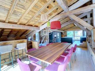 Experience luxury living in this stunning property, featuring a beautifully designed interior with exposed wooden beams and a modern kitchen.