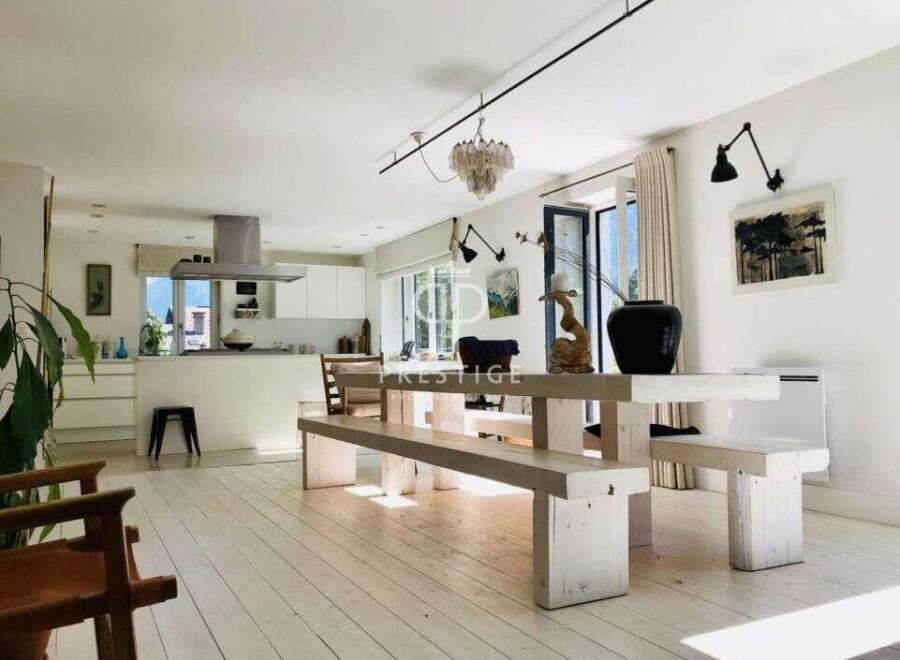 Discover a bright and airy living space with a modern kitchen and a unique dining area.