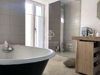 Discover luxury living in this stunning property! Featuring a modern bathroom with a sleek shower and a relaxing bathtub, perfect for unwinding.
