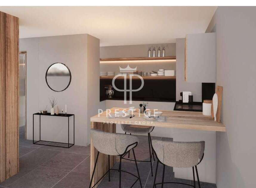 Discover modern living in this stunning property, featuring a sleek kitchen design with a breakfast bar perfect for casual dining.