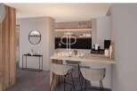 Discover modern living in this stunning property, featuring a sleek kitchen design with a breakfast bar perfect for casual dining.