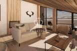 Experience luxury living in this stunning property, featuring a cozy living room with a fireplace and a comfortable sofa.