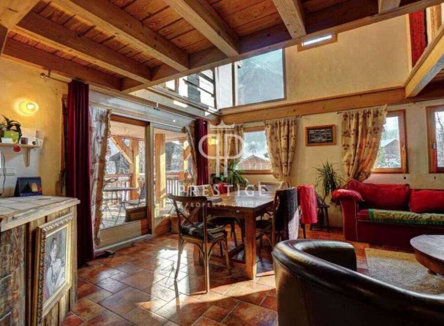 Discover the charm of this rustic property, featuring a warm and inviting interior with exposed wooden beams and a cozy fireplace.